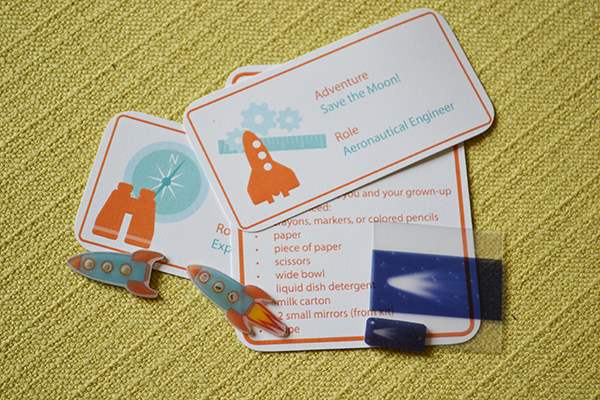 photo of visual design components of adventure cards and plastic rocket buttons